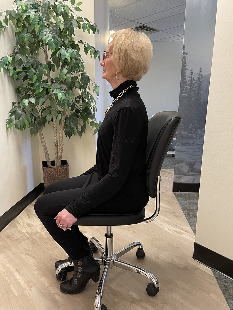 Woman sitting in office chair.